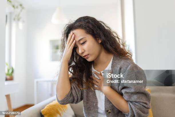 Breathing Respiratory Problem Asthma Attack Pressure Chest Pain Sun Stroke Dizziness Concept Portrait Of Woman Received Heatstroke In Hot Summer Weather Touching Her Forehead Stock Photo - Download Image Now