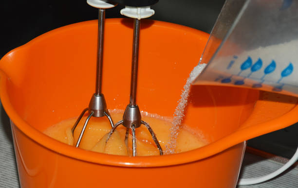 istock kneading the baking dough. a bowl for cooking, a mixer whips eggs with flour and sugar. 1455728404