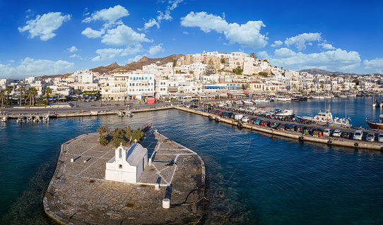 Panoramic view of the town at Naxos island, Cyclades, Greece, with the little church of Mirtidotisa in front of the harbour