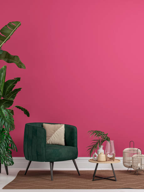 Cozy retro-chic interior with an art deco armchair and potted plants, 50s- 60s decoration Cozy retro-chic interior with a green velvet armchair soft textile chair in front of a sangria red / pink plaster wall background with copy space. A low coffee table with ceramic containers, vases, candles on the white hardwood floor, brown carpet, birdcage lamps, and decoration (lush foliage: monstera, banana/palm tree, pillow). The 50s- 60s decoration, art deco style. A slight vintage effect was added. 3D rendered image. art deco vase stock pictures, royalty-free photos & images