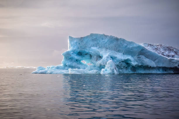 iceberg floating on water in the arctic sea at sunset at Ilulissat icefljord, Greenland