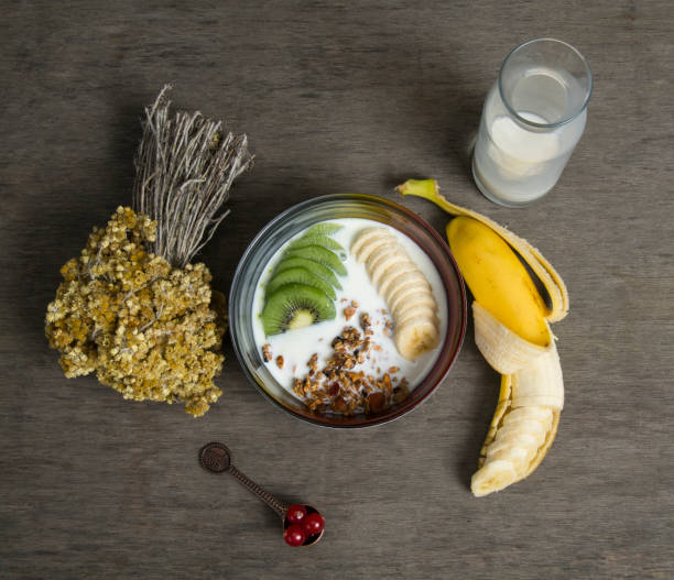 Granola served with milk ,banana, pineapple Granola , breakfast ,banana , diet , healthy food renkli fotoğraf stock pictures, royalty-free photos & images