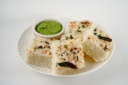 Spongy white dhokla - popular Gujarati steamed breakfast with rice or rava served with green chutney