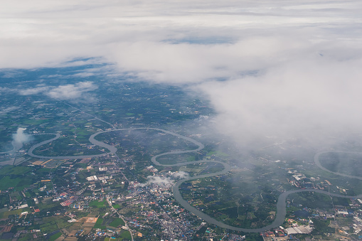 Aerial view scene of Bangkok urban city which are under white fluffy clouds and clear bright blue sky background