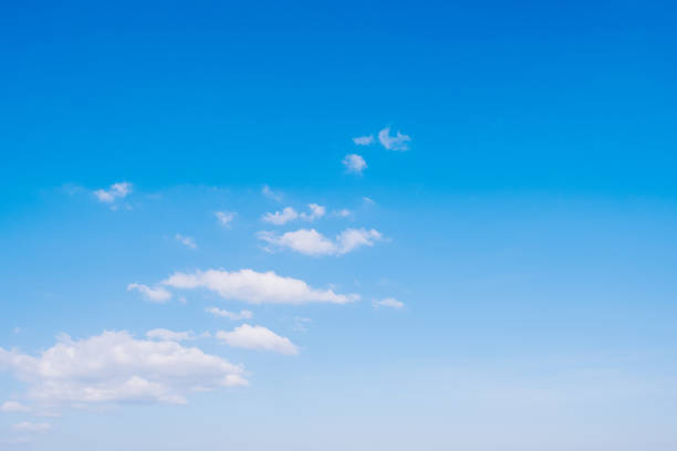 istock White fluffy clouds on beautiful clearly deep blue sky in a sunny day 1455739988
