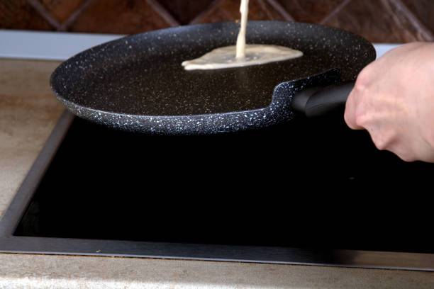 istock photo of pancake batter pouring into a pan 1455740023