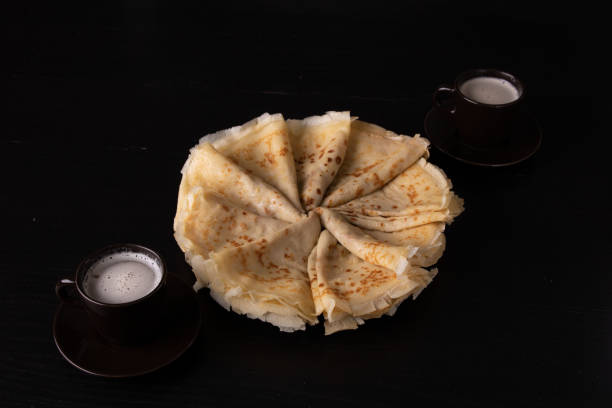 istock photo pancakes on a plate laid in a circle with two cups 1455740663