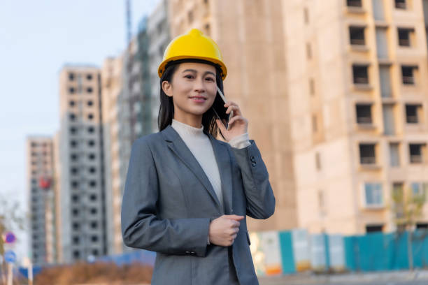 istock Confident beautiful Asian businesswoman holding a clipboard 1455743473