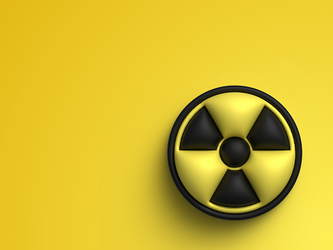 Radiation sign on a black stone background. Copy space. The concept of nuclear confrontation