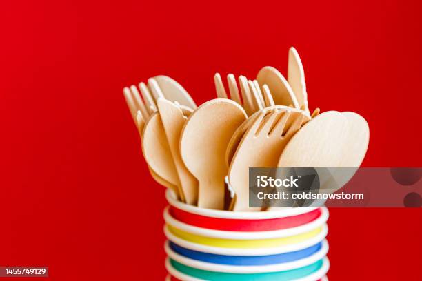 Eco Friendly Recyclable Wooden Cutlery And Paper Cups On Red Background Stock Photo - Download Image Now