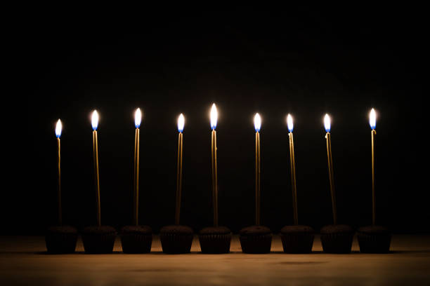 Burning birthday candles on black background