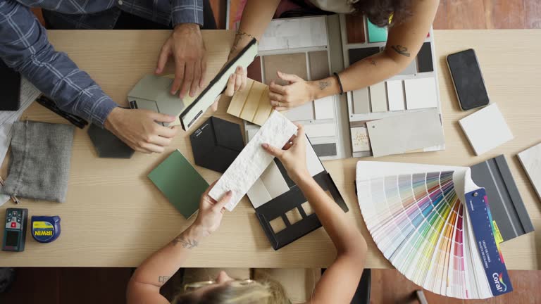 Interior designer and clients discussing tile and color options in her office