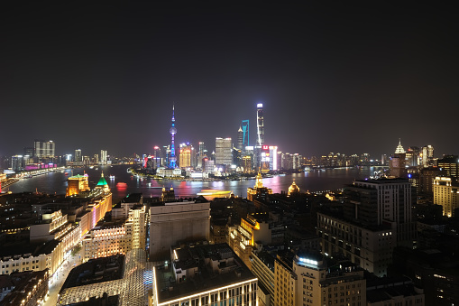 super wide angle of Shanghai city skyline and Huangpu river at night. Aerial view long exposure