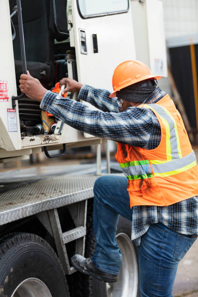 istock African-American man climbing into crane 1455753260