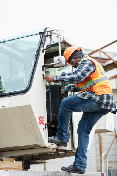 istock African-American man climbing into crane 1455753428