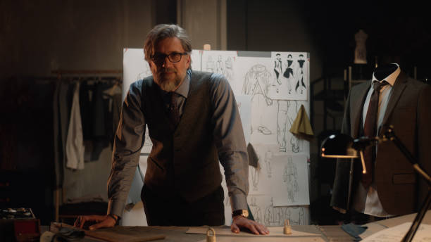 istock Male tailor in atelier looks at camera 1455753463