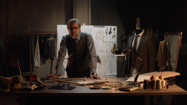 istock Male tailor in atelier looks at camera 1455753482