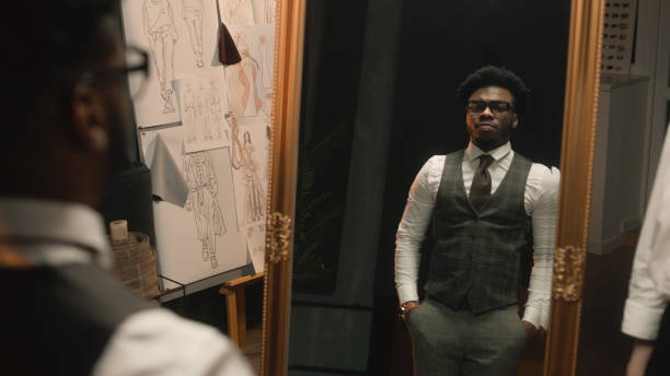 istock Tailor puts jacket on man in luxury clothing shop 1455753541