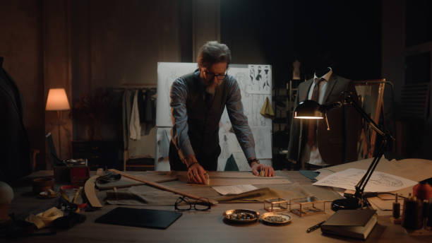 istock Tailor works with sketch of future garment 1455753549