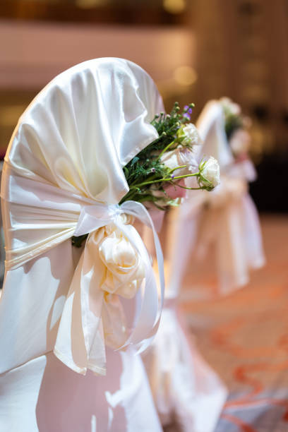 istock Wedding reception chairs decorated with mixed roses and bright satin ribbons 1455754055
