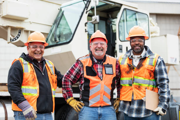 Three multiracial construction workers looking at camera stock photo