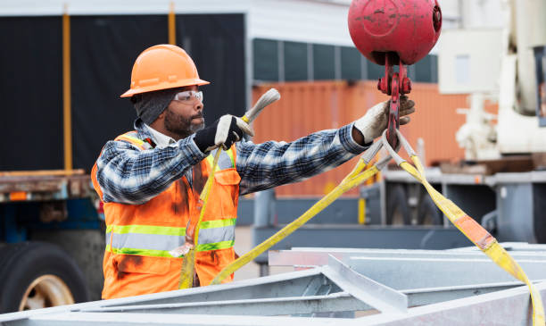 istock African-American man prepares object to lift with crane 1455755359