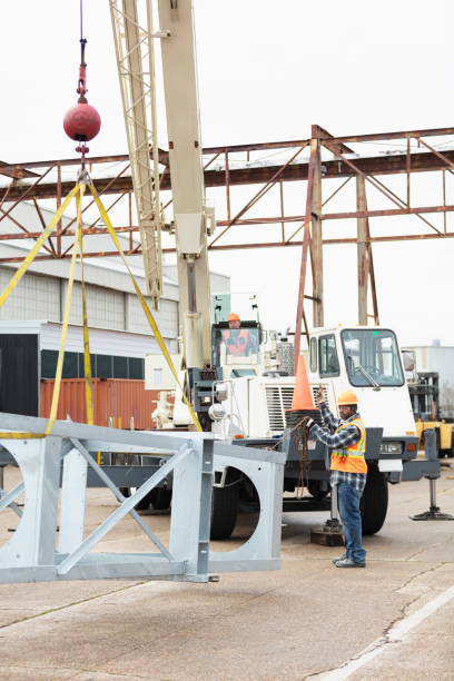 istock African-American man directs crane operator 1455756383