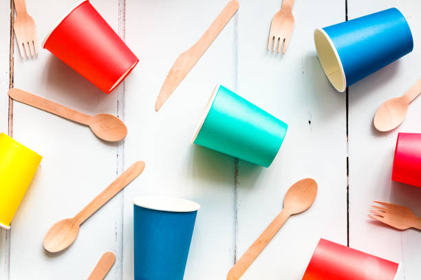 istock Colorful recyclable paper cups and wooden kitchenware utensils on white background 1455757023