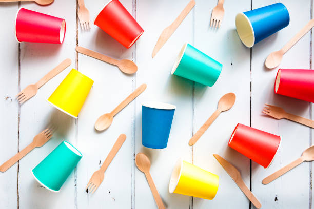 istock Colorful recyclable paper cups and wooden kitchenware utensils on white background 1455757036