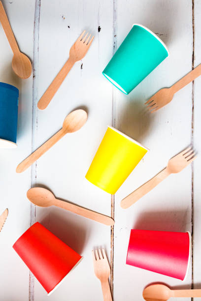 istock Colorful recyclable paper cups and wooden kitchenware utensils on white background 1455757040