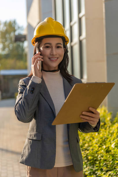 istock Young female site engineer with a safety vest and hardhat 1455757914