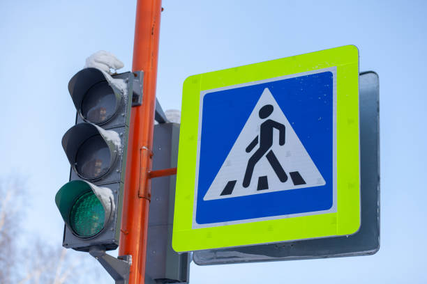 istock A pedestrian crossing sign with a reflective coating and traffic light 1455758264