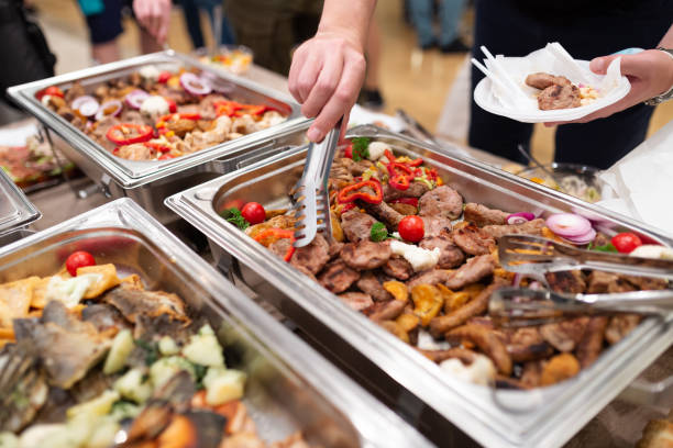 istock Fresh barbecue grill meat at buffet catering table. People serving themselves 1455758470