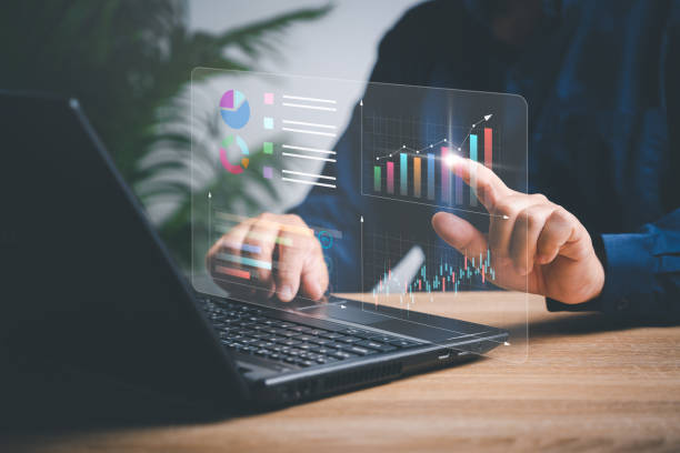 istock Businessman working on laptops to smart digital marketing on virtual screen, Analyzes the profitability of working companies with digital augmented reality graphics, and develop the organization 1455758589