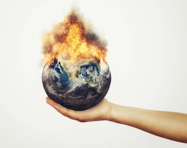 istock Young environmentalist woman supports burning Planet Earth on her hand, representing global warming 1455759741