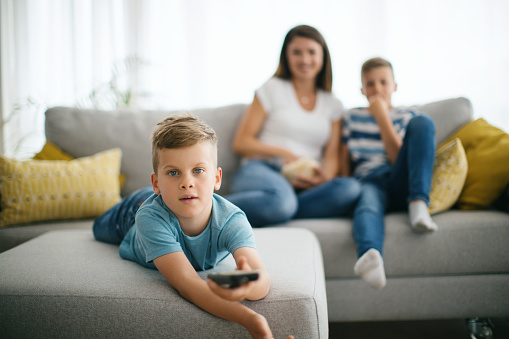 Family watching tv together at home