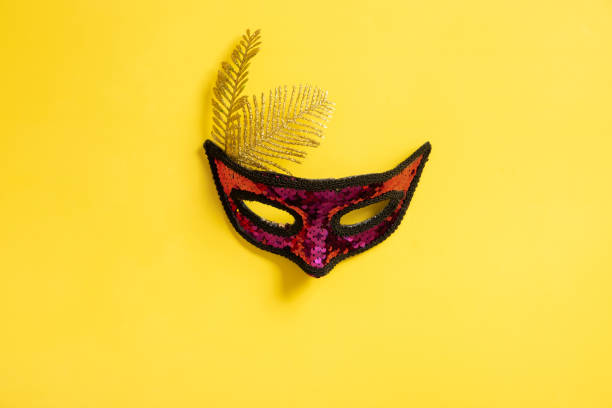 istock Festive face mask for carnival celebration on colored background 1455762022