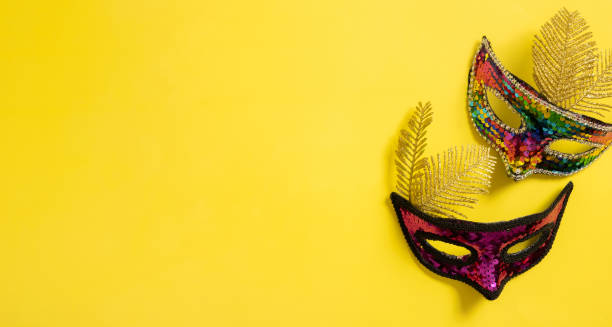 istock Festive face mask for carnival celebration on colored background 1455762030
