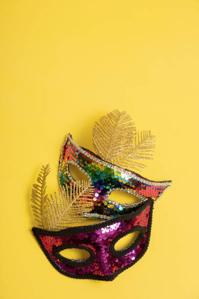 istock Festive face mask for carnival celebration on colored background. Vertical format 1455762034