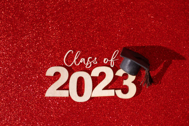 istock Class of 2023 concept. Numbers 2023 with black graduated cap on glitter red background 1455762144