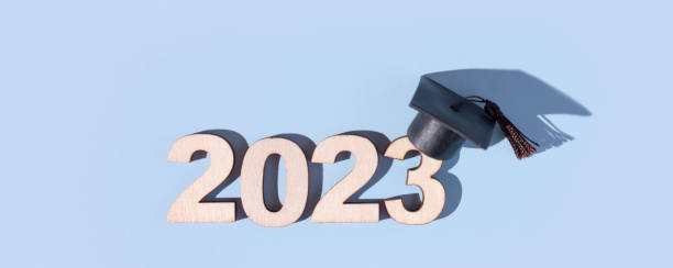 istock Class of 2023 concept. Banner with numbers 2023 with black graduated cap on colored background 1455762161