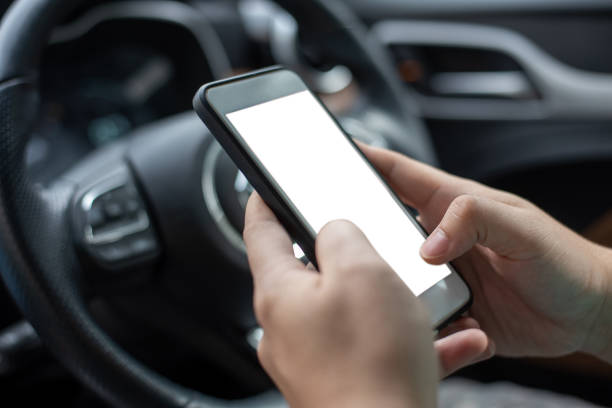 istock cell phone with a blank screen. Men hand holding their phones while texting on a sofa in their home office. a blank white space for advertising text. business, interpersonal communication. 1455764098