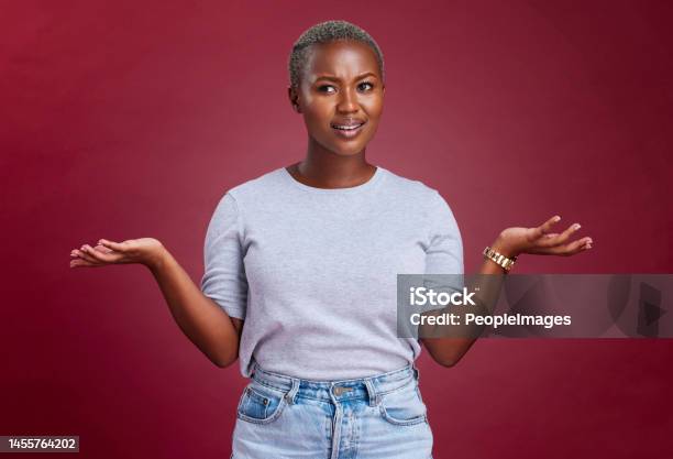 Confused Question And Why Black Woman On Studio Red Background Body Language And Facial Gesture For Risk Decision Shrug And Reaction Uncertainty Unsure And Frustrated Model Doubt And Confusion Stock Photo - Download Image Now