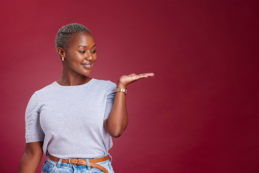 Studio woman, advertising mockup and red background, marketing space and blank wall design for presentation, product placement and promo commercial. Happy young black model, mock up and offer advice