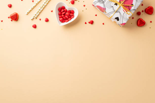 valentine's day concept. top view photo of present box heart shaped plate with sprinkles chocolate candies and straws on isolated pastel beige background with copyspace - valentines day candy chocolate candy heart shape imagens e fotografias de stock