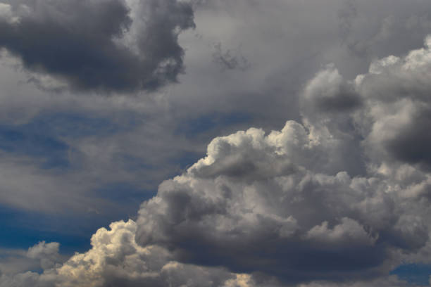 istock windblown cumulus cloud, with bright edges and shadowed center, floating under a misty blue sky. 1455766374