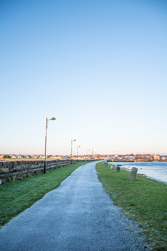 frozen pavement along the banks of the river Corrib in galway on a beautiful winter morning