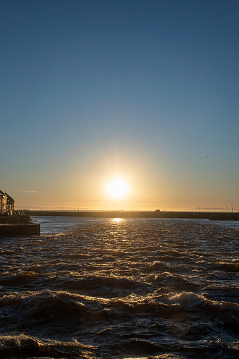 Rapids on the river Corrib at Glaway with choppy waters and rising sun on a beautiful day