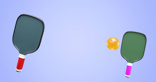 istock Pickleball two rackets and one plastic ball. Copy space 3D rendering 1455769345