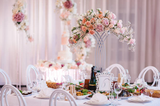 istock Wedding luxury decor and pink flowers. Wedding reception table setting on wedding day. A composition of flowers and greenery is on a festive table at the wedding banquet hall. Close up. 1455769487
